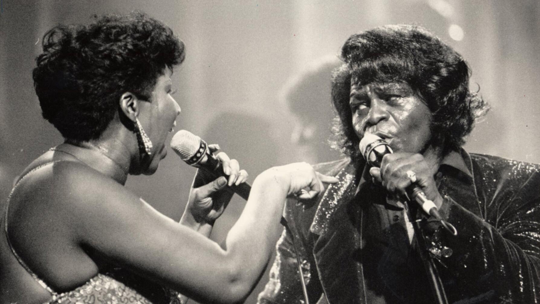 James Brown, right, performs with Aretha Franklin in Detroit in January 1987.
